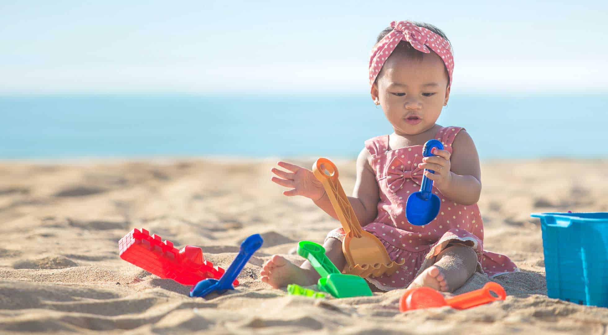 sensory play of the touch and texture of sand at the beach children